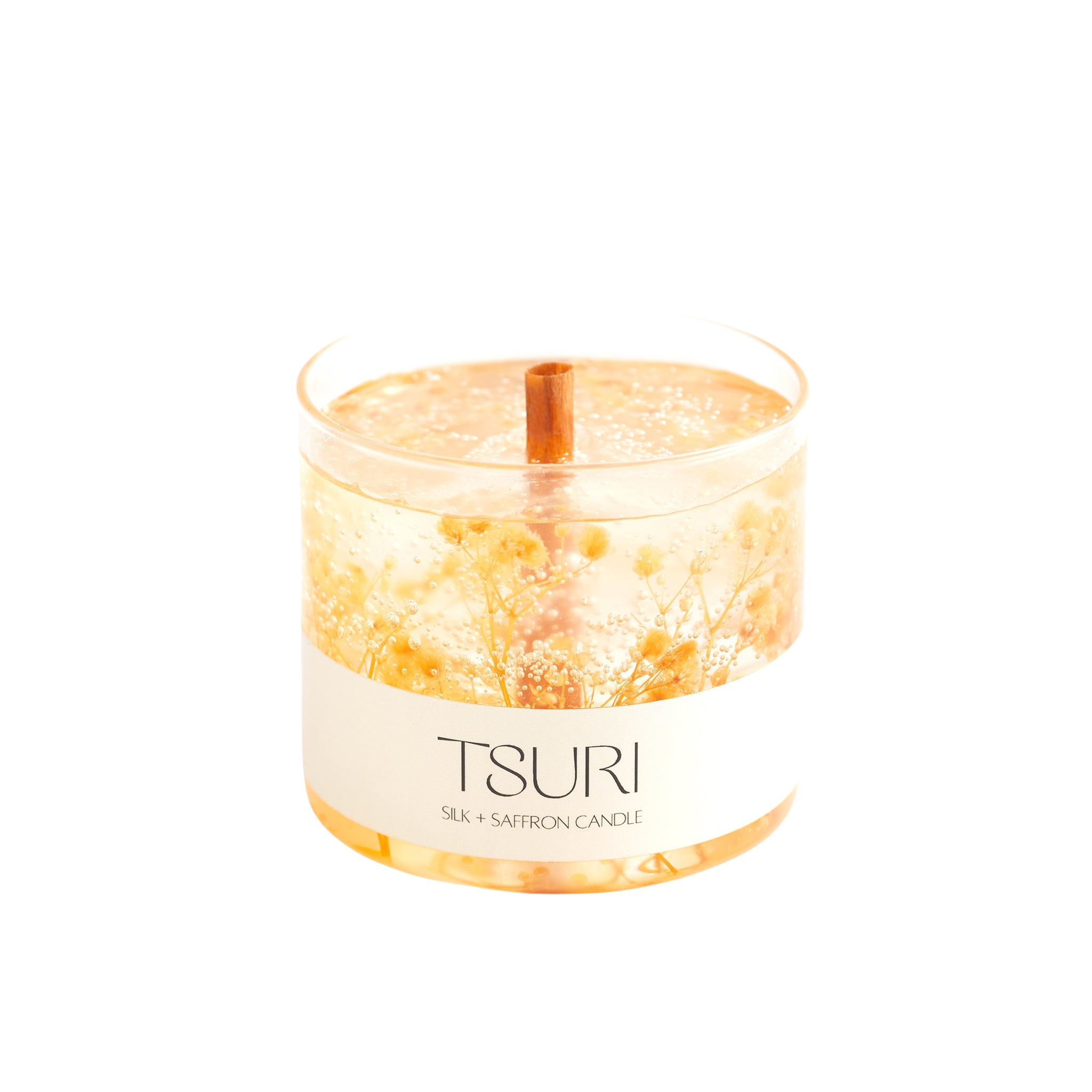 Silk + Saffron Signature Scented Candle with wooden wick and organic botanicals, emitting a warm glow for a sensual ambiance.