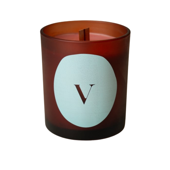 Breathe candle with green tea, lavender, eucalyptus scent in a brown glass holder, perfect for relaxation and unwinding.