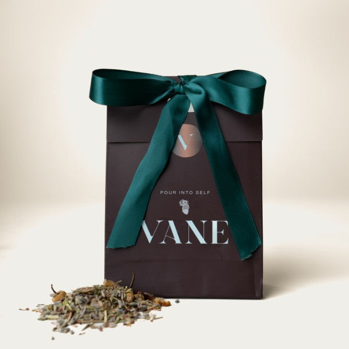 VANE Loose Leaf Tea with calming blend of lavender, chamomile, and honeybush in elegant packaging with green ribbon.