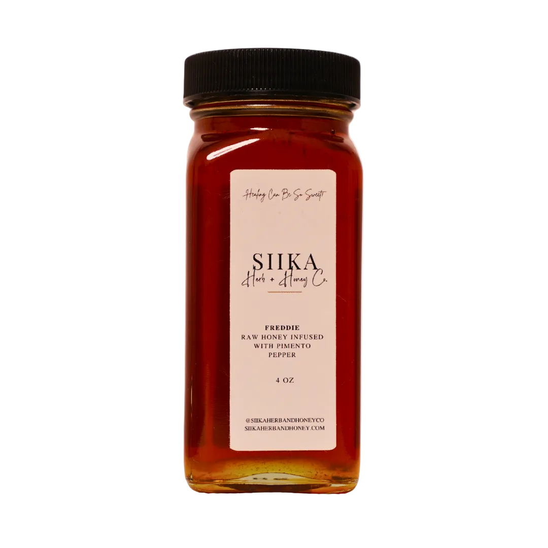 Freddie Sweet Chili Honey jar infused with raw honey and pimento pepper, 4 oz. Perfect for marinades, glazes, and drizzling.