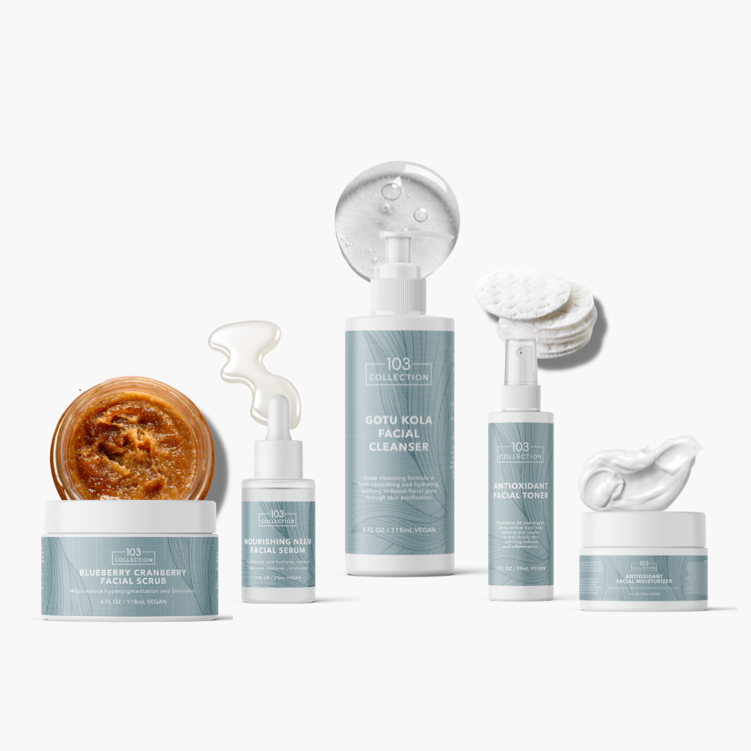 Skincare collection featuring Antioxidant Facial Toner, Gotu Kola Cleanser, Facial Scrub, and cream in elegant packaging.