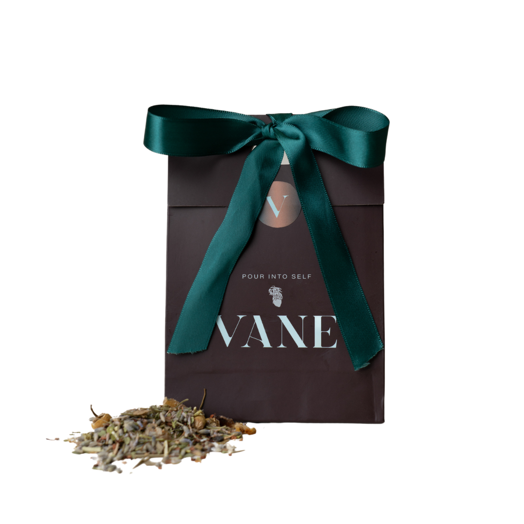 VANE Loose Leaf Tea with lavender, chamomile, eucalyptus, and honeybush in a decorative package with a green ribbon