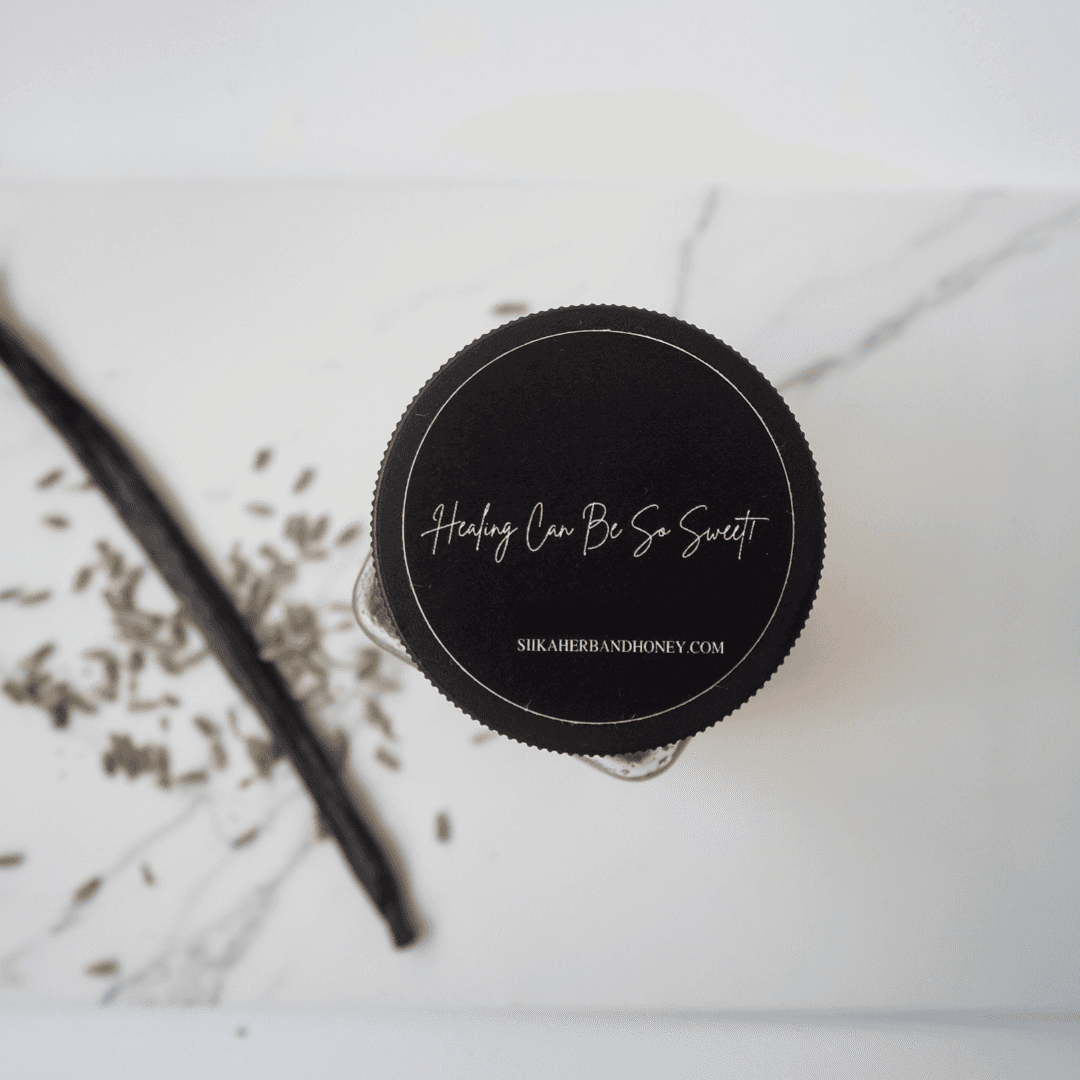 Jar of Yaayo Vanilla & Lavender Honey with vanilla bean and lavender on marble.